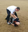 Applicant cuffs a dummy as part of his Physical Agility Test